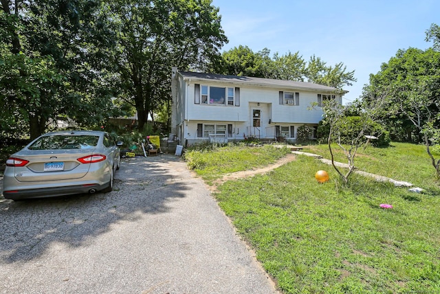 split foyer home featuring a front lawn