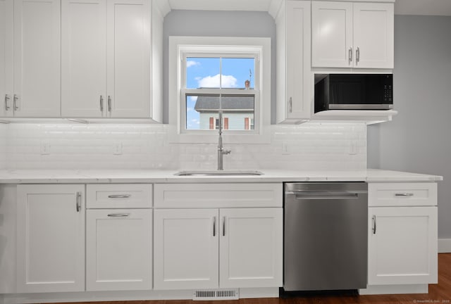 kitchen featuring visible vents, a sink, backsplash, white cabinets, and dishwasher