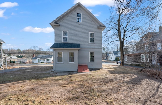back of property with a lawn