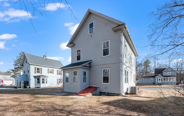 rear view of property featuring central AC