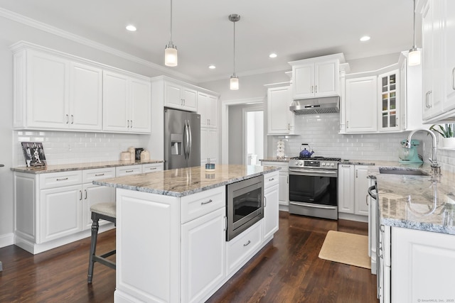 kitchen with under cabinet range hood, stainless steel appliances, white cabinets, and a sink