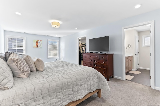 bedroom with light carpet, recessed lighting, a closet, baseboards, and a spacious closet