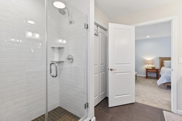 full bathroom featuring ensuite bath, a shower stall, baseboards, and tile patterned flooring