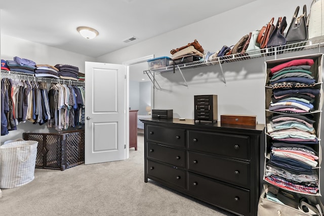 walk in closet with visible vents and light carpet