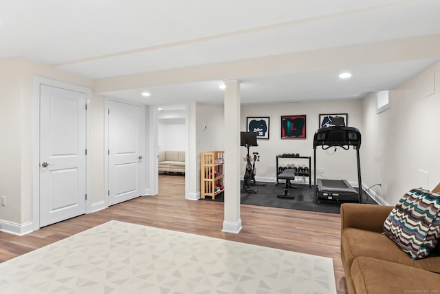 exercise area with recessed lighting, baseboards, and wood finished floors