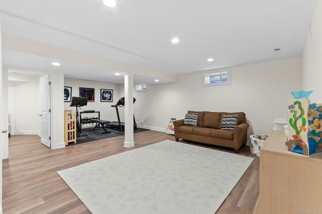 living room featuring light wood-style flooring, recessed lighting, and baseboards