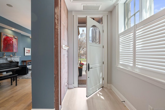 93 Elm St, Hartford, CT 06106 - foyer entrance with visible vents, plenty of natural light, light wood-style flooring, and baseboards