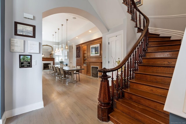 93 Elm St, Hartford, CT 06106 - stairway with a fireplace, arched walkways, wood finished floors, and recessed lighting