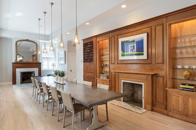 93 Elm St, Hartford, CT 06106 - dining space with recessed lighting, light wood-style flooring, built in shelves, and a fireplace