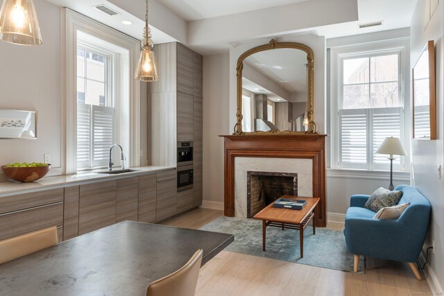 93 Elm St, Hartford, CT 06106 - living room with visible vents, a wealth of natural light, and light wood-style floors