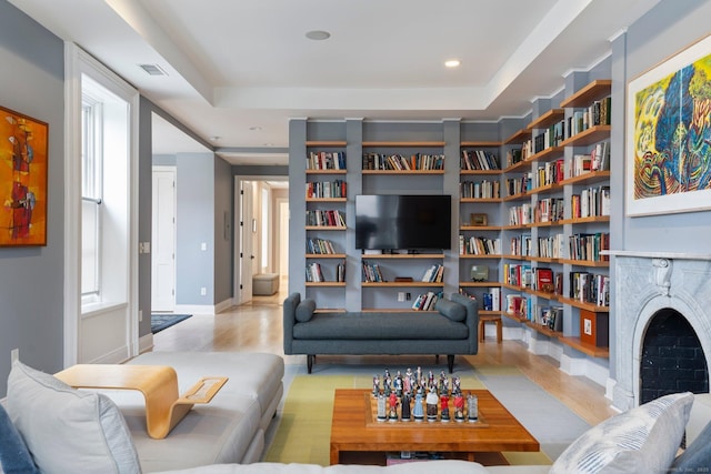93 Elm St, Hartford, CT 06106 - living room with wood finished floors, healthy amount of natural light, a raised ceiling, bookshelves, and recessed lighting