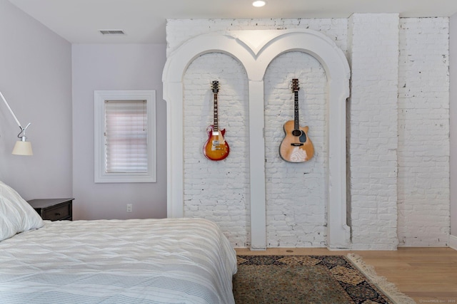 93 Elm St, Hartford, CT 06106 - bedroom with wood finished floors, brick wall, recessed lighting, and visible vents