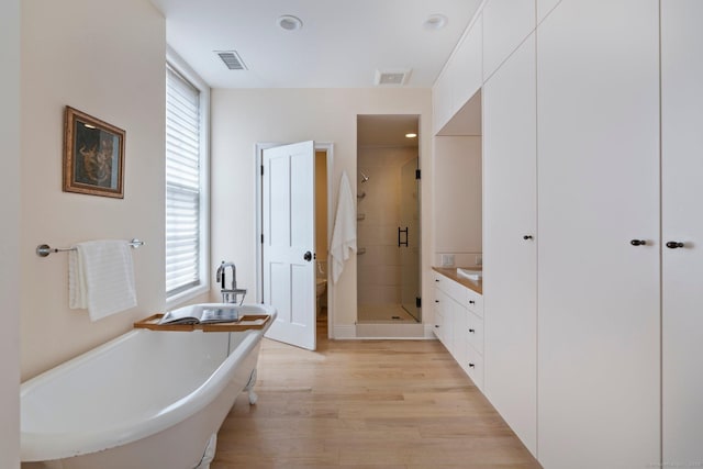 93 Elm St, Hartford, CT 06106 - bathroom with wood finished floors, a freestanding bath, a shower stall, vanity, and visible vents