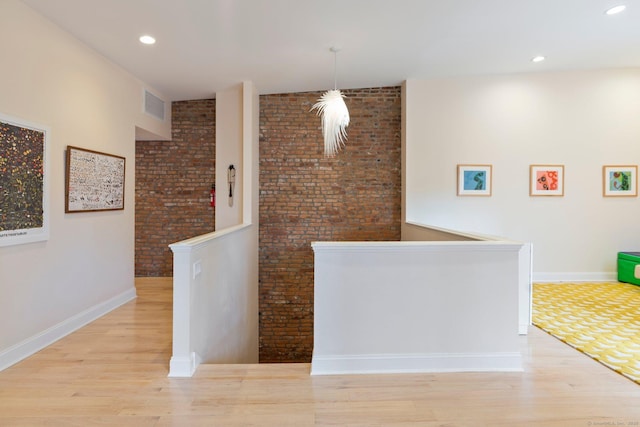 93 Elm St, Hartford, CT 06106 - hall featuring light wood finished floors, an upstairs landing, visible vents, and brick wall