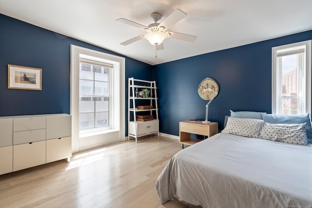 93 Elm St, Hartford, CT 06106 - bedroom with baseboards, wood finished floors, a ceiling fan, and multiple windows