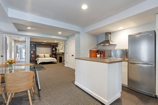 93 Elm St, Hartford, CT 06106 - kitchen featuring modern cabinets, stainless steel countertops, white cabinetry, wall chimney range hood, and freestanding refrigerator