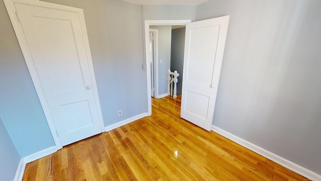 unfurnished bedroom featuring baseboards and light wood-style floors
