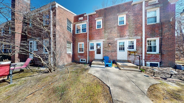 townhome / multi-family property with brick siding and entry steps