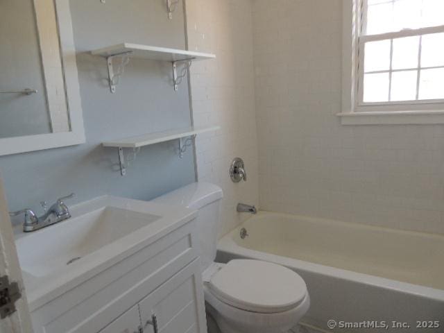 full bath with toilet, vanity, and bathing tub / shower combination