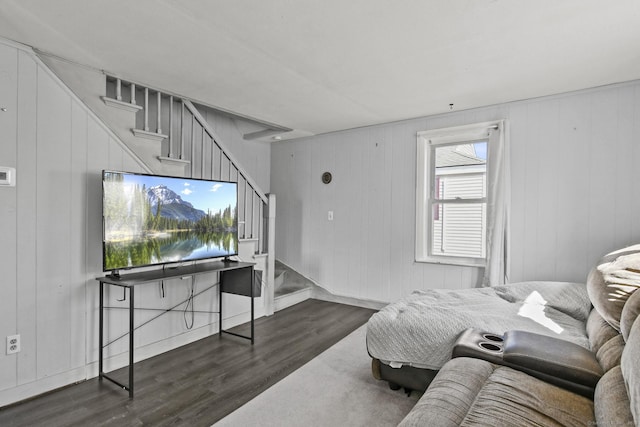 living area with stairway and wood finished floors