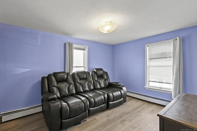 living room with baseboard heating and wood finished floors