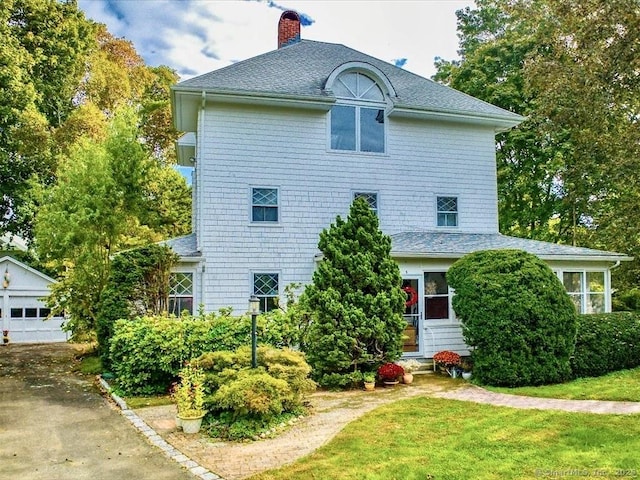 5 Old Pawson Rd, Branford, CT 06405 - exterior space with a yard, a chimney, a garage, and a shingled roof
