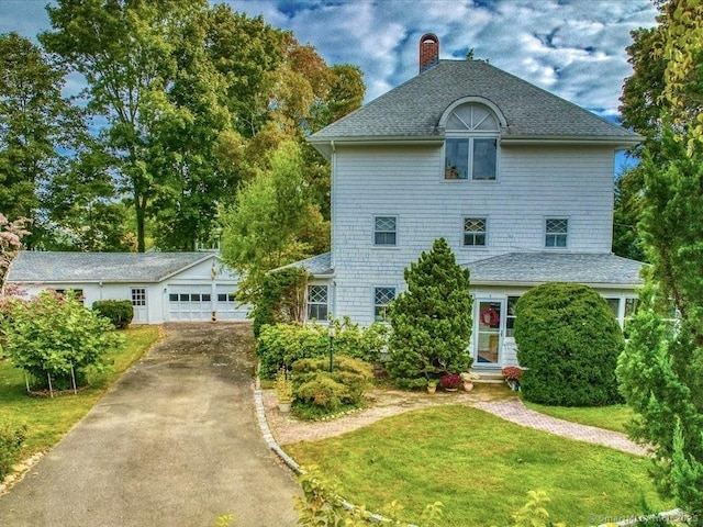 5 Old Pawson Rd, Branford, CT 06405 - view of front of home featuring a garage, driveway, a front yard, and a chimney