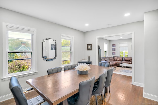 dining space with dark wood finished floors, recessed lighting, and baseboards