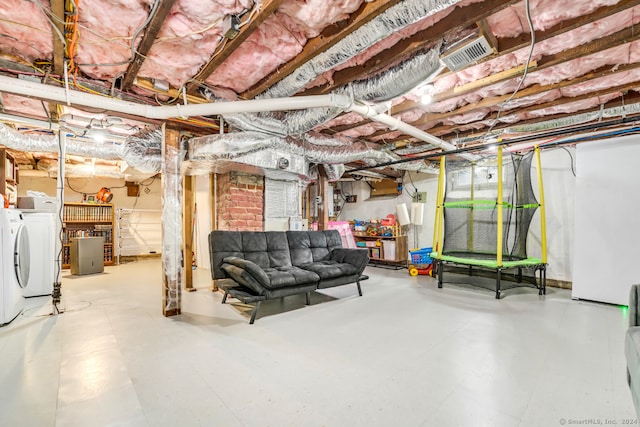 unfinished below grade area featuring washer and dryer, visible vents, and tile patterned floors