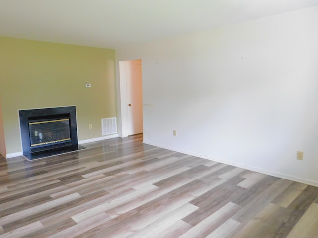 201 Windgate Cir Unit A, Monroe, CT 06468 - unfurnished living room with wood finished floors, a fireplace with flush hearth, and baseboards