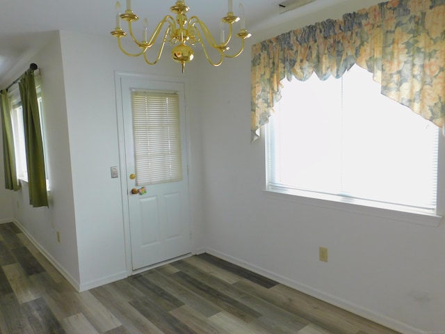 201 Windgate Cir Unit A, Monroe, CT 06468 - unfurnished dining area featuring a chandelier, wood finished floors, and baseboards