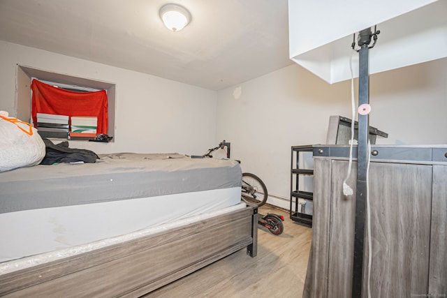 bedroom featuring wood finished floors and baseboards