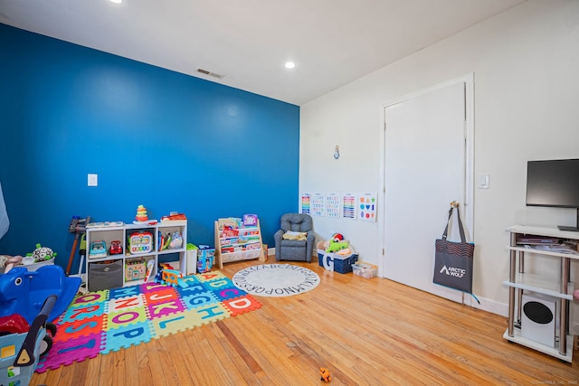 recreation room featuring recessed lighting, wood finished floors, and visible vents