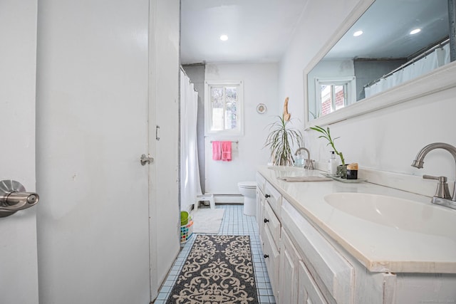 full bath with tile patterned floors, double vanity, toilet, and a sink