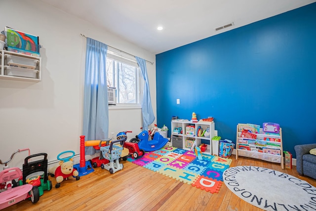 recreation room featuring hardwood / wood-style flooring and visible vents