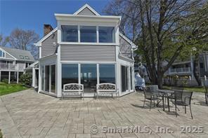 back of property featuring a patio and a chimney