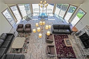 living area featuring a chandelier and a fireplace