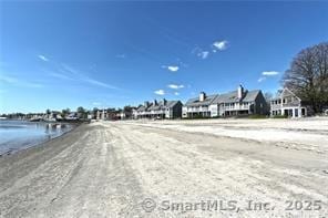 view of street featuring a view of the beach and a water view