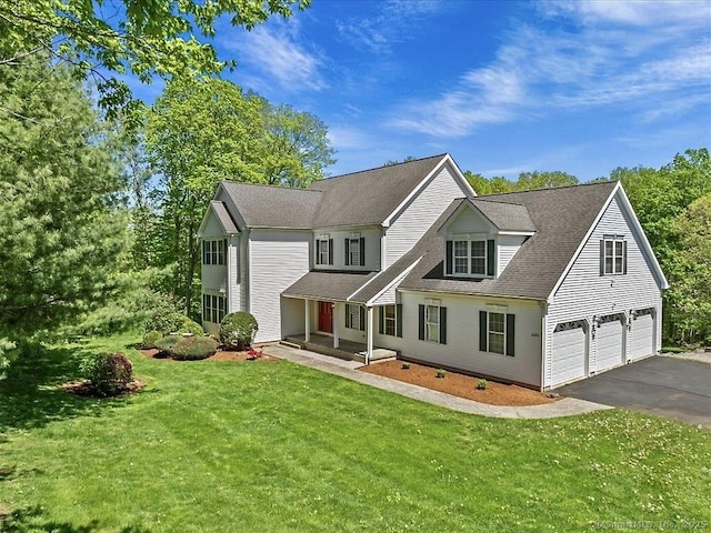 2273 Long Hill Rd, Guilford, CT 06437 - view of front of home featuring asphalt driveway, a garage, a front lawn, and a shingled roof