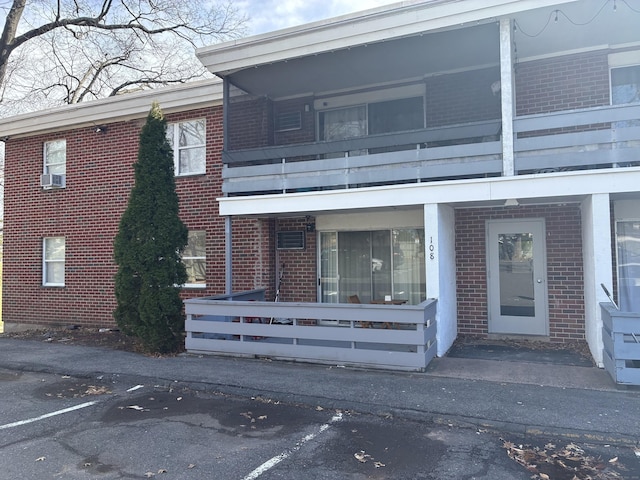 view of building exterior featuring uncovered parking