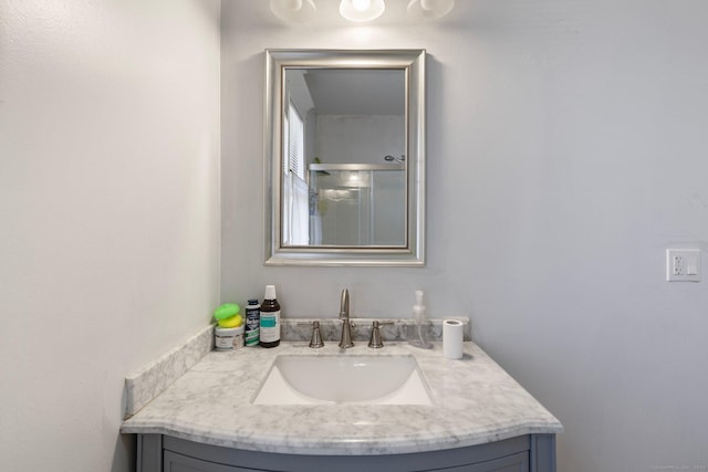 bathroom with an enclosed shower and vanity