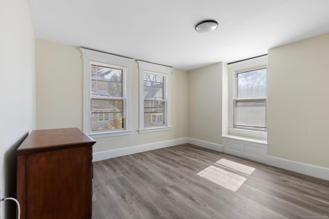 empty room featuring baseboards and wood finished floors
