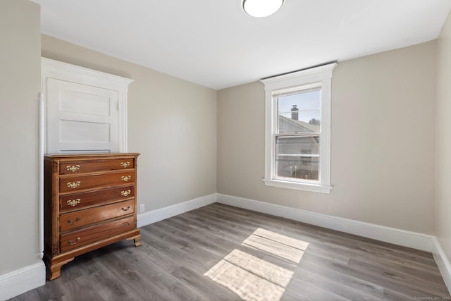 unfurnished bedroom with baseboards and wood finished floors