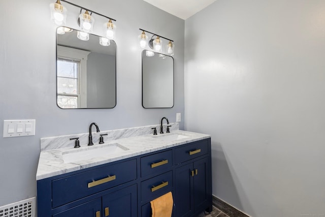 bathroom featuring double vanity, baseboards, and a sink