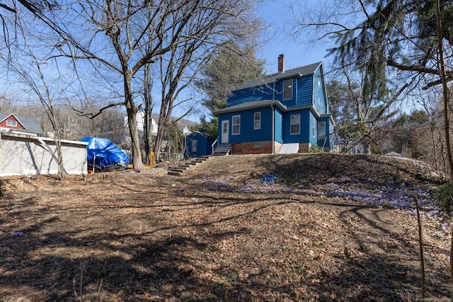 view of side of property featuring a chimney