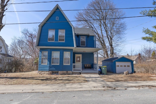 view of front of house featuring a gambrel roof, driveway, a porch, an outdoor structure, and a garage
