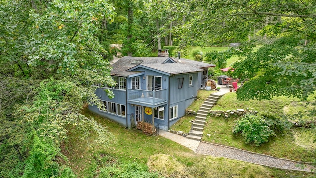 25 Brookbridge Dr, Newtown, CT 06482 - exterior space with a shingled roof, a front lawn, a balcony, and a chimney