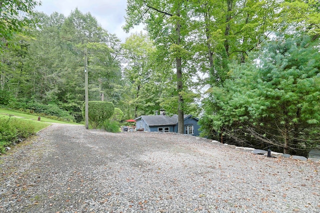 25 Brookbridge Dr, Newtown, CT 06482 - exterior space with a chimney, gravel driveway, and a wooded view