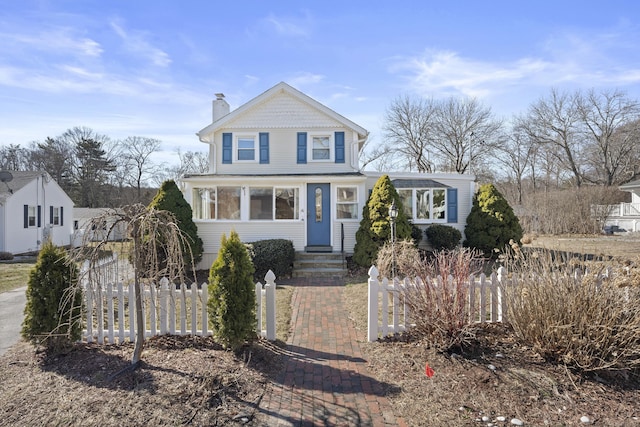view of front of property with a fenced front yard and a chimney