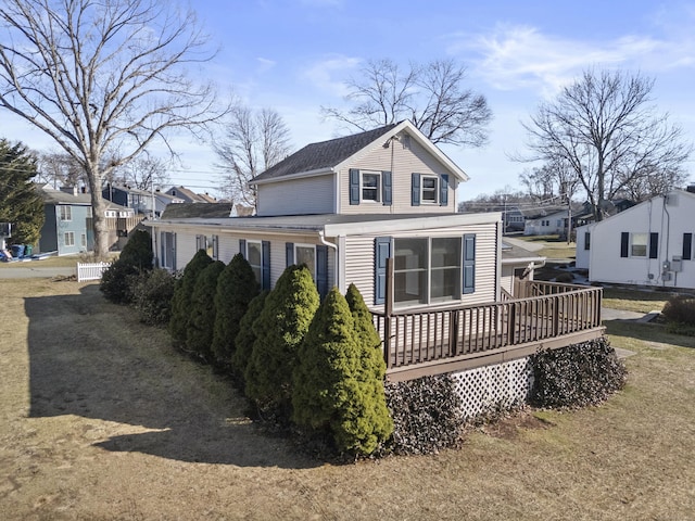 view of front of home featuring a residential view and a wooden deck